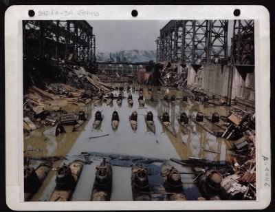 ␀ > General View Of Bomb-Damaged Drydock At Kure, Japan.  This Drydock Had Approximately Fifty-Nine Two-Man Submarines Mounted One On Top Of The Other.  Deck Was Flooded By Usa Soldiers During Early Days Of Occupation.  February 1946.