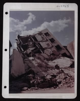 ␀ > This Building On The Excolta In Manilla, P.I. Was Completely Blasted From Its Mooring And Tossed On Its Side From The Force Of The Explosion During The Battle For Manilla. Photographer Q. R. Porter, 4-22-45.