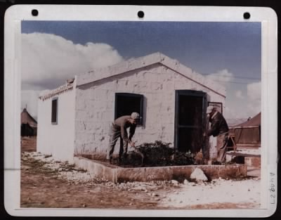 Thumbnail for ␀ > Sgt. David Pulizzi, Chicago Il., (Left) & S/Sgt. John E. Eming, Cleveland, Oh Has The Garden In Front Of Their Stone Hut. 15Th Af In Italy.