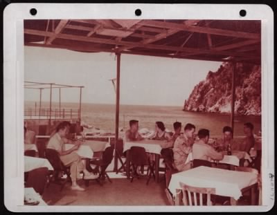 ␀ > After A Morning Spent In Swimming Or Boating, These Army Air Forces Restees On The Isle Of Capri Have Lunch In The Terrace Retaurant At The Enlisted Men'S Beach At Piccola Marina.