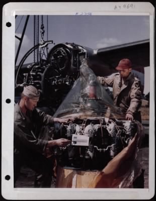 Thumbnail for General > Ground Crewmen Sgt James V. Blakney Of Langsford, Penn, And Msgt Charles W. Carrigan Of Nashville, Tenn, Make An Engine Change At An 8Th Af Base Somewhere In England.