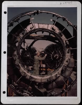 General > Plane View- Seen Through The Engine Cowling Ring Of A B-17 Is Msgt Harrell Parrah, Mexico, Mo  He Is Repairing The Engine Of A B-17 That Will Soon Take Off For Mission Over Germany.