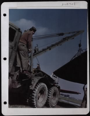 Thumbnail for General > Many Pieces Of B-17 'Little Miss Mischief' Will Fly Again.  After The Plane Belly-Landed Returning From A Mission Over Germany All Useable Parts Were Salvaged.  At Extreme Left The Crane Operator Cpl. James Mulhollen Of Somerset, Pa., At Extreme Right T/S