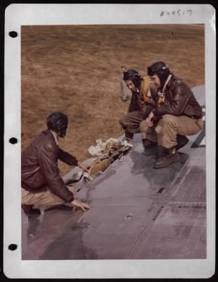 Battle Damage > Crew Of The Boeing B-17 'Peacemaker' Examines Battle Damage To The Wing Of The Plane.