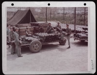 ␀ > Ordnance Men Loading 100 Lb. Demolition Bombs Onto Trailers. England.