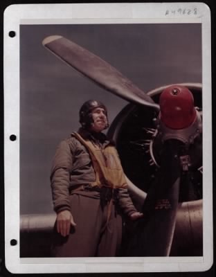 Bomber > Capt. Charles S. Hudson, Bombardier, Standing By A Plane At A Base In England.