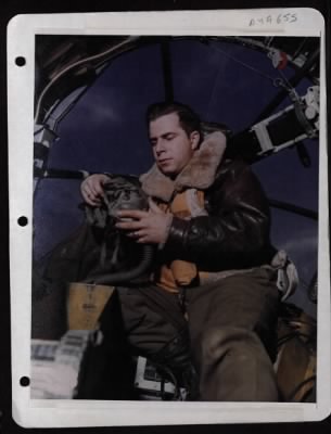 Bomber > Capt. Louis Detoni Adjusts His Oxygen Mask In Preparation For Coming Mission Against Enemy Installations. Photograph Unknown.