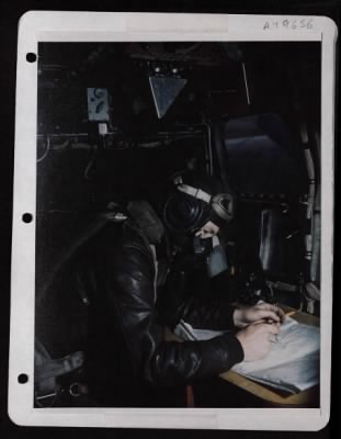 Bomber > In The Nose Of The 8Th Af Boeing B-17 'Flying Fortress', Lt. Grant H. Benson, Navigator From Stambaugh, Michigan, Charts The Course To A German Industrial Target.  Film Received 7 October 1944.