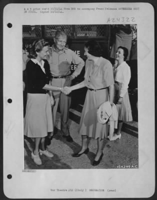 Consolidated > Somewhere in Italy, Katherine Cornell meets Madeleine Carroll. Behind them is the bus in which Miss Cornell's troupe is touring Italy to present "The Barretts of Wimpole Street" for the armed forces. Miss Carroll left Hollywood to become a Red Cross