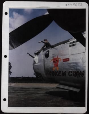 Ground > M/Sgt. James F. Mcginn, Crew Chief Of St. Paul, Minn., Sits On Top Of The Consolidated B-24 'Hookem Cow'.
