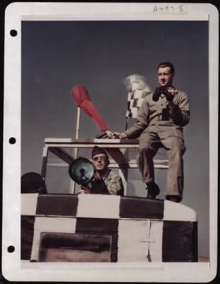 Thumbnail for NAGA Head Hunters > Sgt. Carlton W. Fulford, Of Senoia, Georgia, Gives The Green Light To A Plane Coming In To Land As Pvt. Edward H. Burlingame, Of Dunkirk, New York, Checks Its Progress To Warn Off Any Possible Encroachment On The Landing Plane. They Are In A Mobile Flying