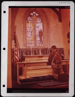 ␀ > An Airman Prays...Before Going Into Combat, Sgt Thomas M. Barber Of Seattle, Wa, Kneels Before The Altar At The 96Th Bombardment Group Chapel.  The Window In The Background Honors The Dead Of The Group.  Before Going Into Combat, Many Airmen Say A Silent