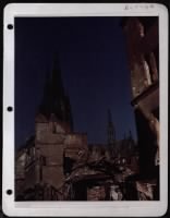 Spires Of The Famous Cologne Cathdral, Untouched By Allied Bombings Of The City, Rise Above Bomb Damages Inflicted On Railway Buildings Near The Important Lines Which Feed The Western Front. - Page 1