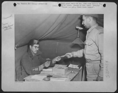 Consolidated > Left, Maj. Ovidio Beraldo, From Sao Paulo, Finance Officer Of The First Brazilian Fighter Squadron, Pays Off Pvt. Augusto Villas-Boas, An Orderly Room Clerk.  The Maj. Was Once An Assistant To The Minister Of The War.  The Pvt. Was A Lawyer In Civilian Li
