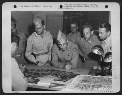 Consolidated > Major General Nathan F. Twining Studies A Mosaic At A 90Th Photo Reconn Wing Base Somewhere In Italy.