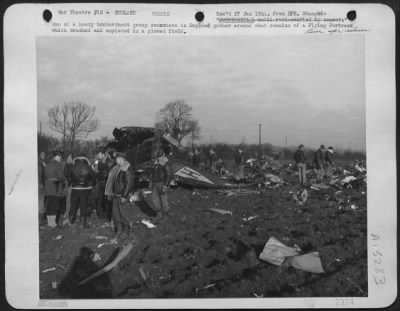 Consolidated > Men Of A Heavy Bombardment Group Somewhere In England Gather Around What Remains Of A "Flying Fortress" Which Crashed And Exploded In A Plowed Field.