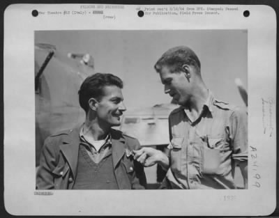 Consolidated > Left, Lt. Robert Duncan, 521 West Ormsoy, Louisville, Ky, Sports A Rumanian Air Force Wing, Which Lt. Gerald B. Elliot Of Austin Texas Is Examining.  Both These Men Were Among The More Than 1,000 American Airmen Brought Back To Italy When Rumania Surrende