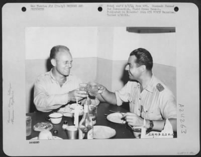 Consolidated > Lt. Colonel James A. Gunn Iii Of 1522 Texas Street, San Antonio, Texas (Left) Who Arranged The Mass Evacuation Of Over 1,000 Former Hun Prisoners From Rumania, Is Shown Here Drinking A Toast To Capt. Bazu Cantacuzino, A Rumania Pilot Converted To The Alli
