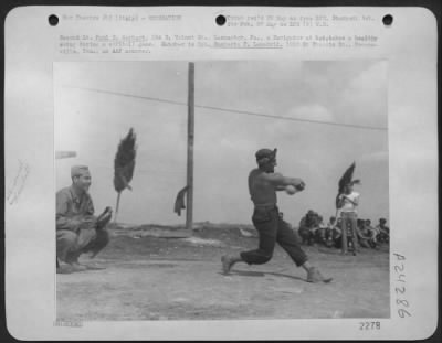 Consolidated > 2Nd Lt. Paul E. Gerhart, 104 E. Walnut St., Lancaster, Pa., A Navigator At Bat, Takes A Healthy Swing During A Softball Game.  Catcher Is Cpl. Humberto T. Lamadrid, 1222 St. Francis St., Brownsville, Tex., An Aaf Armorer.