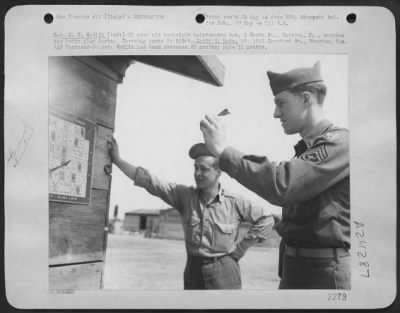 Consolidated > Sgt. K.F. Sydlik (Left) 21 Year Old Bombsight Maintenance Main, 2 South St., Natrona, Pa., Watches His Buddy Play Darts.  Throwing Darts Is S/Sgt. David M. Mabe, 19, 1012 Crawford St., Houston, Texas, Aaf Engineer-Gunner.  Sydlik Has Been Oversears 20 Mon