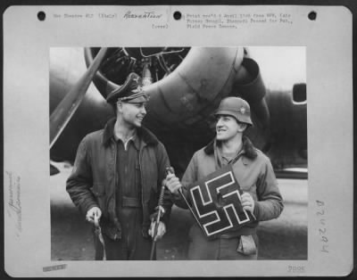 Consolidated > These Two Men Hold Souvenires Brought From Poland At A Base Somewhere In Southern Italy.  Nazi Emblem Is From Part Of A Nazi Glider.  Men Are Left To Right, S/Sgt. John E. Young, Monroe, La., S/Sgt. Salvitor M. Novarra, 5602 S. Racine Ave., Chicago, Ill.