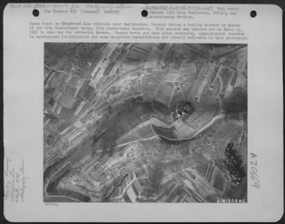 Consolidated > Bombs Burst On Siegfried Line Defenses Near Zweibrucken, Germany During A Bombing Mission By Planes Of The 17Th Bombardment Group, 95Th Bombardment Squadron.  This Mission Was Carried Out On March 15, 1945 To Make Way For Advancing Troops.  Dragon Teeth A
