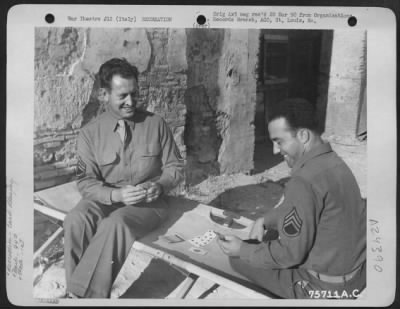 Consolidated > Two Members Of The 94Th Fighter Squadron, 1St Fighter Group, Relax As They Play A Game Of Cards At An Airfield Somewhere In Italy.