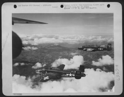 Consolidated > North American B-25 Mitchells of the 9th Air force en route to bomb Nazi ground installations in direct support of the ground forces.