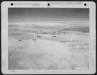 Thumbnail for Consolidated > Boeing B-17 "Flying Fortress" Of The 381St Bomb Group, En Route To Bomb Enemy Installations In Europe, Are Silhouetted Against A Blanket Of Fleecy Clouds.