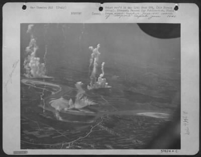 Thumbnail for Consolidated > Fantastic Towers Of Smoke Rise From Anti-Aircraft Positions Neutralized By A Force Of 57Th Bomb Wing North American B-25 Mitchells.  Other Mitchell Bombers Successfully Attacked A Motor Transport Ferry That The Flak Guns Were Defending.  The Target Is In