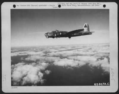 Thumbnail for Consolidated > A Lone Boeing B-17 "Flying Fortress" Of The 381St Bomb Group Wings Its Way To Attack An Enemy Installation In Europe.  As It Floats Majestically Along Over Fleecy Clouds It Is Not Alone; There Are More - Many More - Above, Behind And In Front Of It.