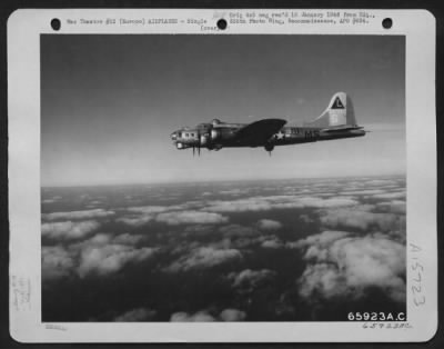 Consolidated > The Boeing B-17 "Flying Fortress" 'Chug-A-Lug' Of The 381St Bomb Group, En Route To Bomb Enemy Installations In Europe, Flies High Above Fleecy Clouds.