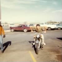 Bobby Gene McKinney on motorcycle in barracks parking lot.