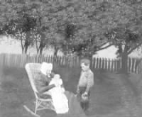 Mary Twohy Bresnan, holding grandaughter, grandson standing nearby