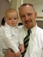 IMG_0604 NNBodB NNJohnB Boden Age 1 with Father John Beutler at KT & Caleb Wedding Luncheon 20100619.JPG