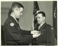 REcieving his BRONZE STAR with "V" for VALOR.