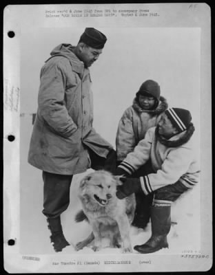 ␀ > Joe Louis In Eskimo Land  Like Kids The World Over, These Eskimo Boys Are Probably Trying To Tell T/Sgt. Joe Louis All About Their Wonderful Dog -- Unsuccessfully, Inasmuch As The World'S Heavyweight Champion Doesn'T Speak Eskimo.  The Scene Is The U.S. A
