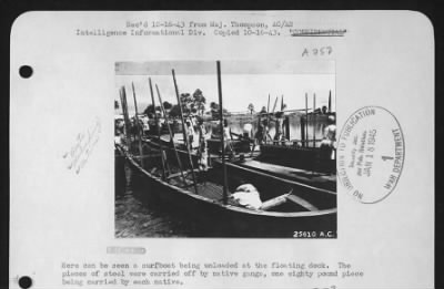 Thumbnail for General > Here can be seen a surfboat being unloaded at the floating dock.  The pieces of steel were carried off by native gangs, one eighty pound piece being carried by each native.