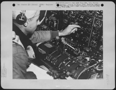 Engineer > Flight Engineer, M/Sgt. Harry C. Miller (Denver, Colorado), of the Boeing B-29 "20th Century Unlimited", at engineer's instrument panel on the return trip to base in China after Mission 9 bombing raid on Anshan, Manchuria. 40th Bomb Group