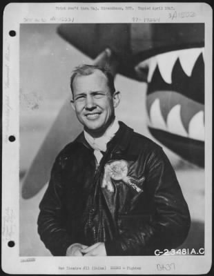 Fighter > Maj. John R. Alison, Gainesville, Florida, an American Volunteer Group Ace (Flying Tigers) poses in front of a Curtiss P-40 at an air base somewhere in China.