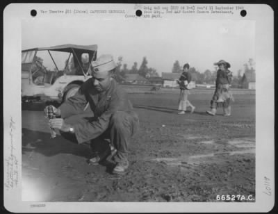 General > Capt. Macallister Of The Ordnance Dept. Of The 40Th Bomb Group, Xx Bomber Command, Removing Fuse From An Unexploded Anti-Personnel Bomb.  China.