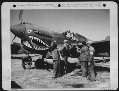 General > Chinese Soldiers And Armorers Of The 74Th Fighter Squadron, 23Rd Fighter Group, Check The Guns On A Curtiss P-40 At Kunming, China, 1 February 1943.  The Armorers Are:  T/Sgt. Hugh L. Jenkins Of Colorado S/Sgt. Harry L. Gray Of Cisco, Texas S/Sgt. Hy D. S