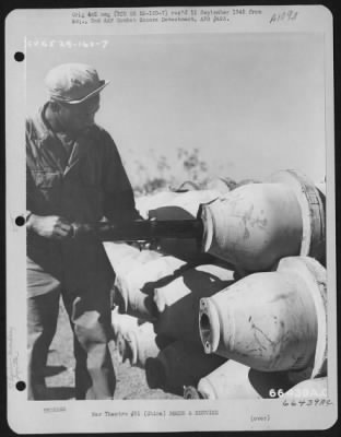 General > The M-5 Igniter Inserted Into The Burster Well Of A M-76 500 Pound Incendiary Bomb, Making Certain That The Pipe Lugs Of The Igniter Are To The Rear.  China.