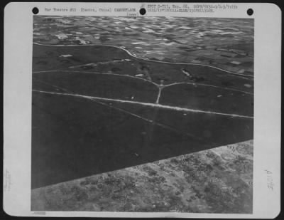 General > This Reconnaissance Photograph Taken On July 22, 1945 Shows Planes In Revetments, And The Painted Camouflage On A Section Of A Runway At White Cloud Airfield, Canton, China.