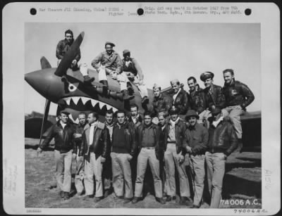 Fighter > Officers Of The 74Th Fighter Squadron, 23Rd Fighter Group, Pose On And By A Curtiss P-40 At Kunming, China, 2 February 1943. They Are: Lt. F.W. Ladd, Lt. D.M. Mitchell, Lt. C.J. Crysler, Lt. L.F. Jones, Lt. W.B. Hawkins, Lt. D.G. Anderson, Lt. C.C. Bunch,