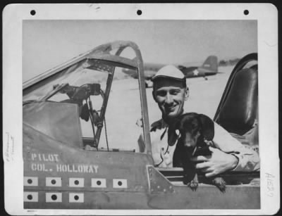 Fighter > Colonel Bruce K. Holloway Is Shown With A Mascot In The Cockpit Of His Aircraft At Kunming, China.  1943.