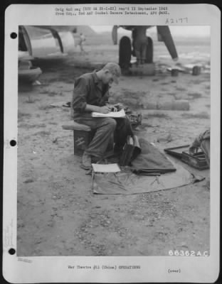 Thumbnail for General > T/Sgt. Joseph R. Hampton, Flight Engineer, Chautaugua, Kansas, Takes Time Out On Returning To China Base After Participating In Mission 9 To Anshan, Manchuria, To Complete Flight Records Of Boeing B-29'S Performance During Flight.  These Boeing B-29'S Wer