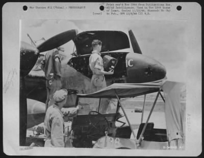 Thumbnail for Cameras > China-Camera repairmen install full magazine on a Lockheed F-5 "Frantic", the F-5 which flew the long-range mission over Yawata, Japan. It was flown over 100 combat mission and has a total time in the air of more than 650 hours.