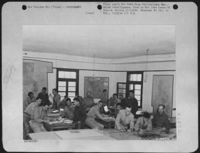 Thumbnail for Operations & Mapping > China-Personnel of the Photogrammetry Section engaged in some of the steps toward the completion of charts produced from tri-metrogon photographs. In the right foreground, a metal-laydown has begun.