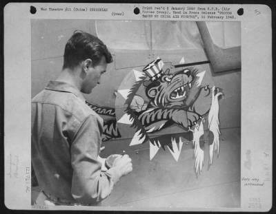 General > Insignia Of The China Air Task Force Fighter Command Is Being Painted On A Plane By Sargeant Larue. It Shows The Flying Tiger Of The American Volunteer Group Now Wearing Uncle Sam'S Hat To Show He Is Fighting For The United States Army Air Force. The Chin